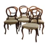 A harlequin set of seven Victorian walnut balloon back dining chairs,