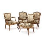 A pair of French carved beech and parcel gilt framed open armchairs,