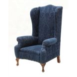 A large wing back armchair,