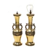 A large pair of brass table lamps