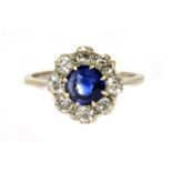A white gold sapphire and diamond circular cluster ring,