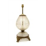 An etched glass and gilt metal table lamp