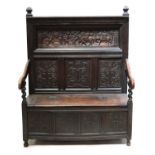 A Victorian carved oak settle,