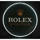 A contemporary 'Rolex Official Retailer' sign,