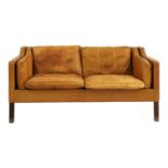 A tan leather 2212 settee,