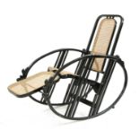 An ebonised wooden rocking chair,