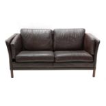 A Danish black leather two-seater settee,