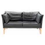 A Danish black leather two seater settee,