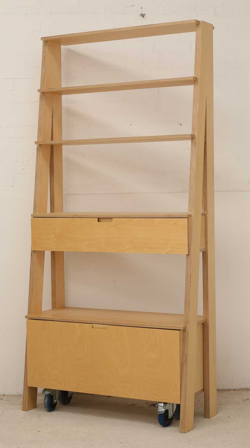 A free-standing set of plywood shelves,
