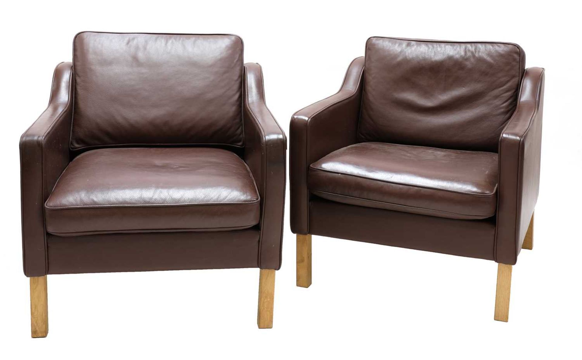A pair of Scandinavian brown leather armchairs,