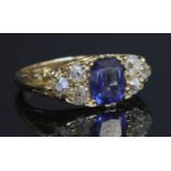 A gold sapphire and diamond carved head ring,