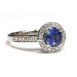 A platinum sapphire and diamond halo cluster ring,