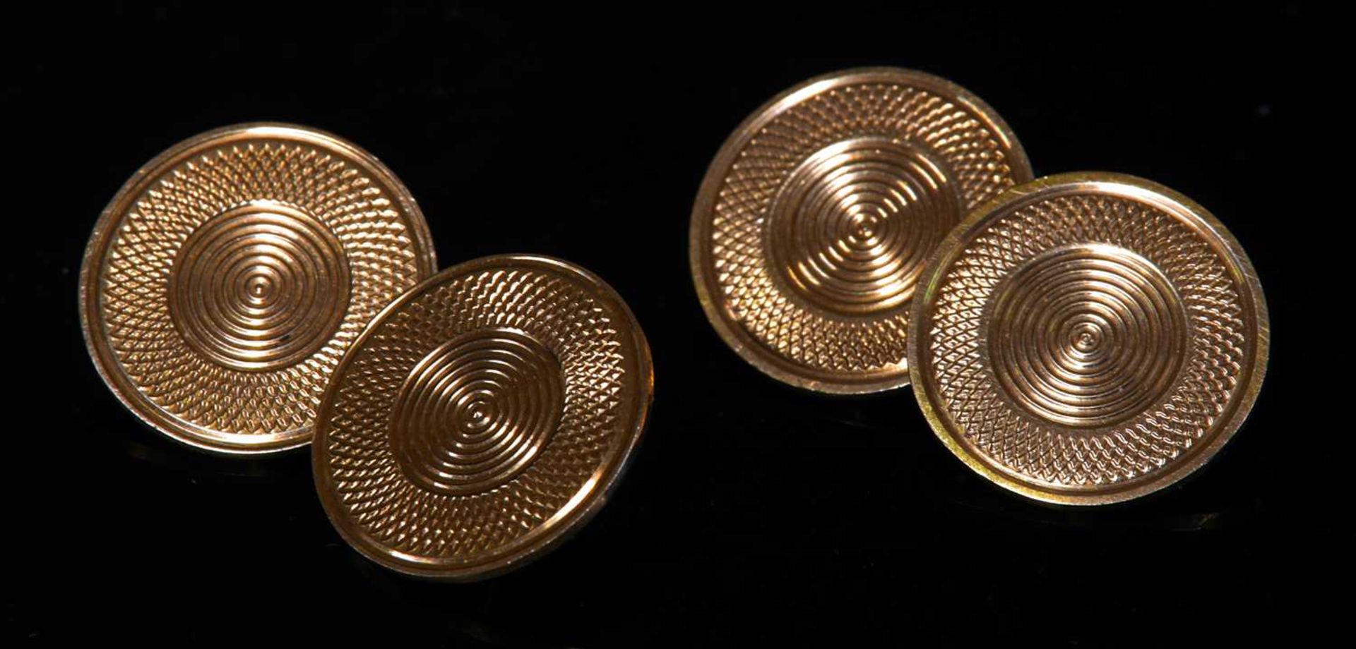 A pair of circular gold chain-link cufflinks,