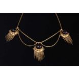 A cased Victorian gold and garnet set Etruscan Revival swag and fringe necklace, c.1860,