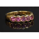 An 18ct gold five stone pink sapphire ring,