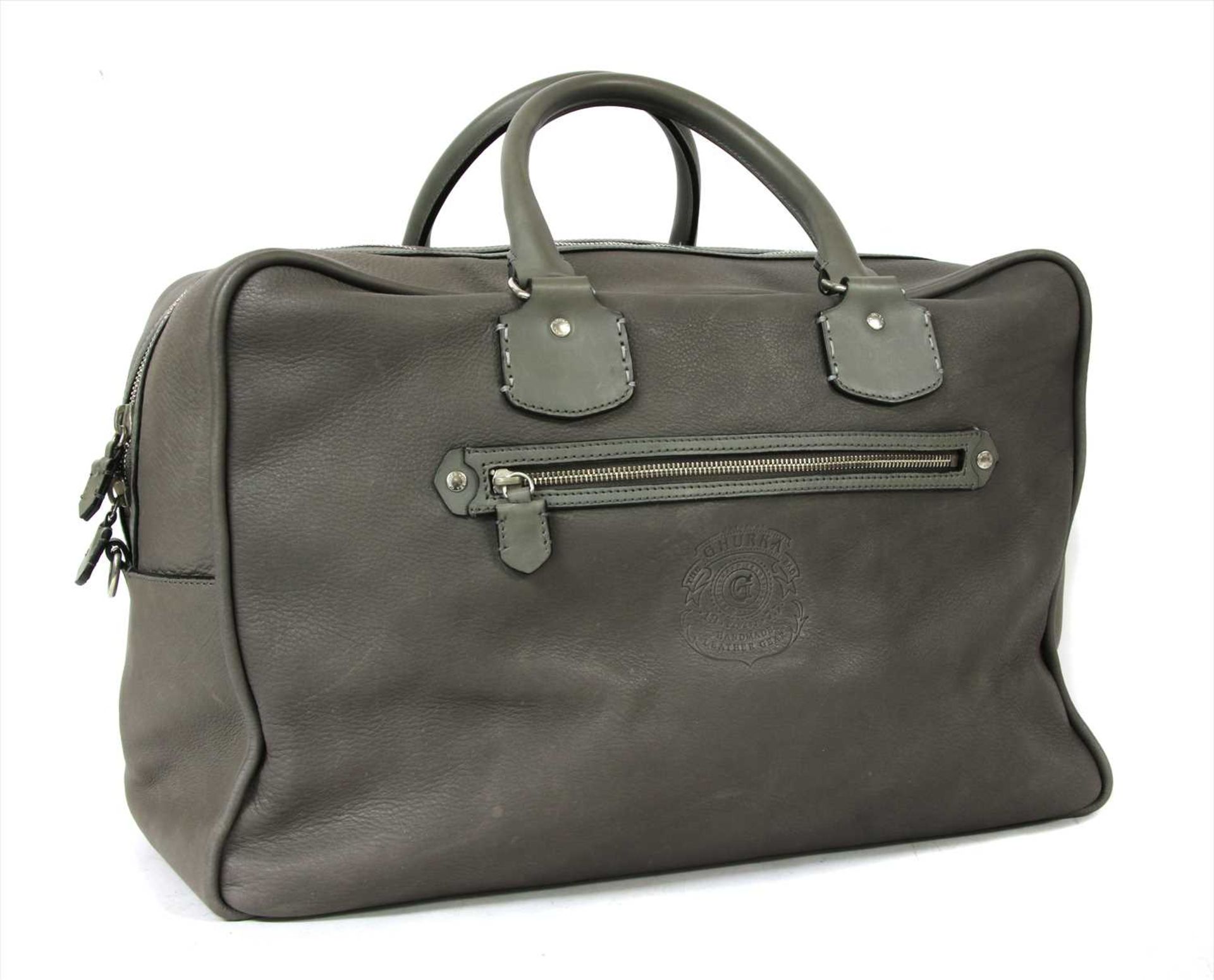 A Ghurka grey leather travel bag,