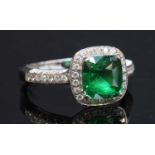 An 18ct white gold tsavorite garnet and diamond halo cluster ring,