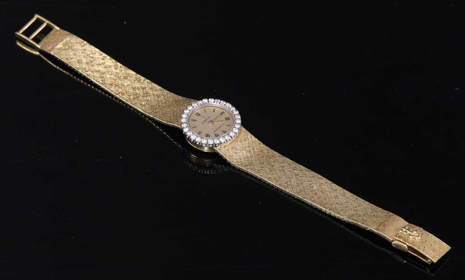 A ladies' 18ct gold diamond set mechanical bracelet watch,