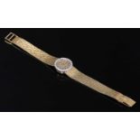 A ladies' 18ct gold diamond set mechanical bracelet watch,