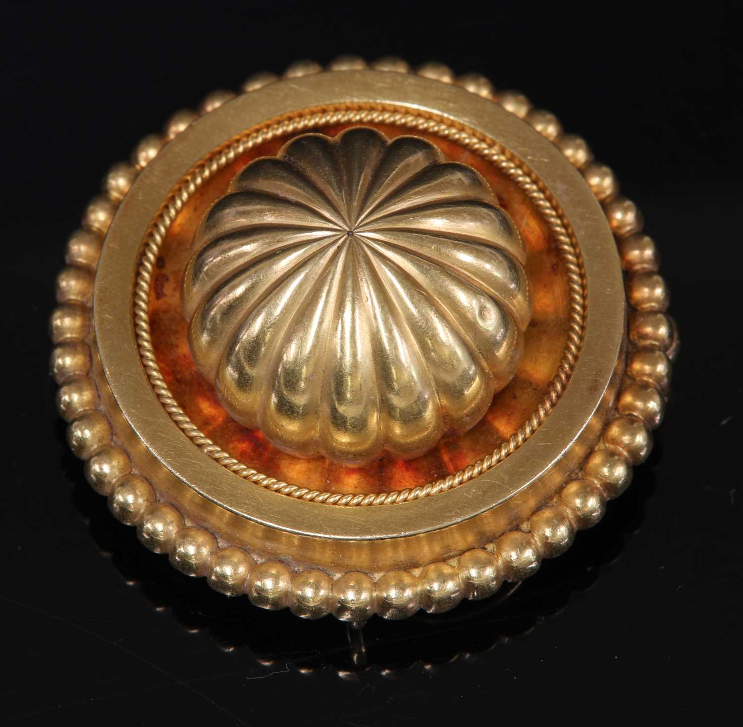 A Victorian Etruscan Revival gold shield form brooch, c.1870,