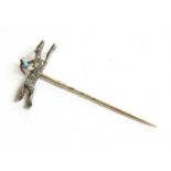 A diamond and enamel jockey on horseback stick pin,