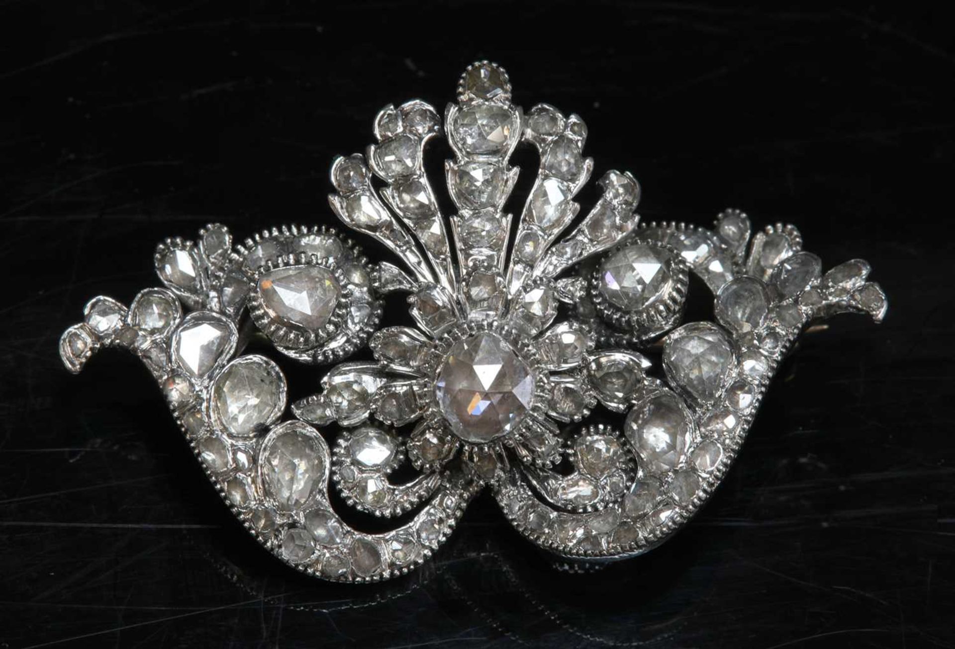 An antique diamond set brooch,