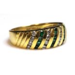 An 18ct gold emerald and diamond diagonal band ring,