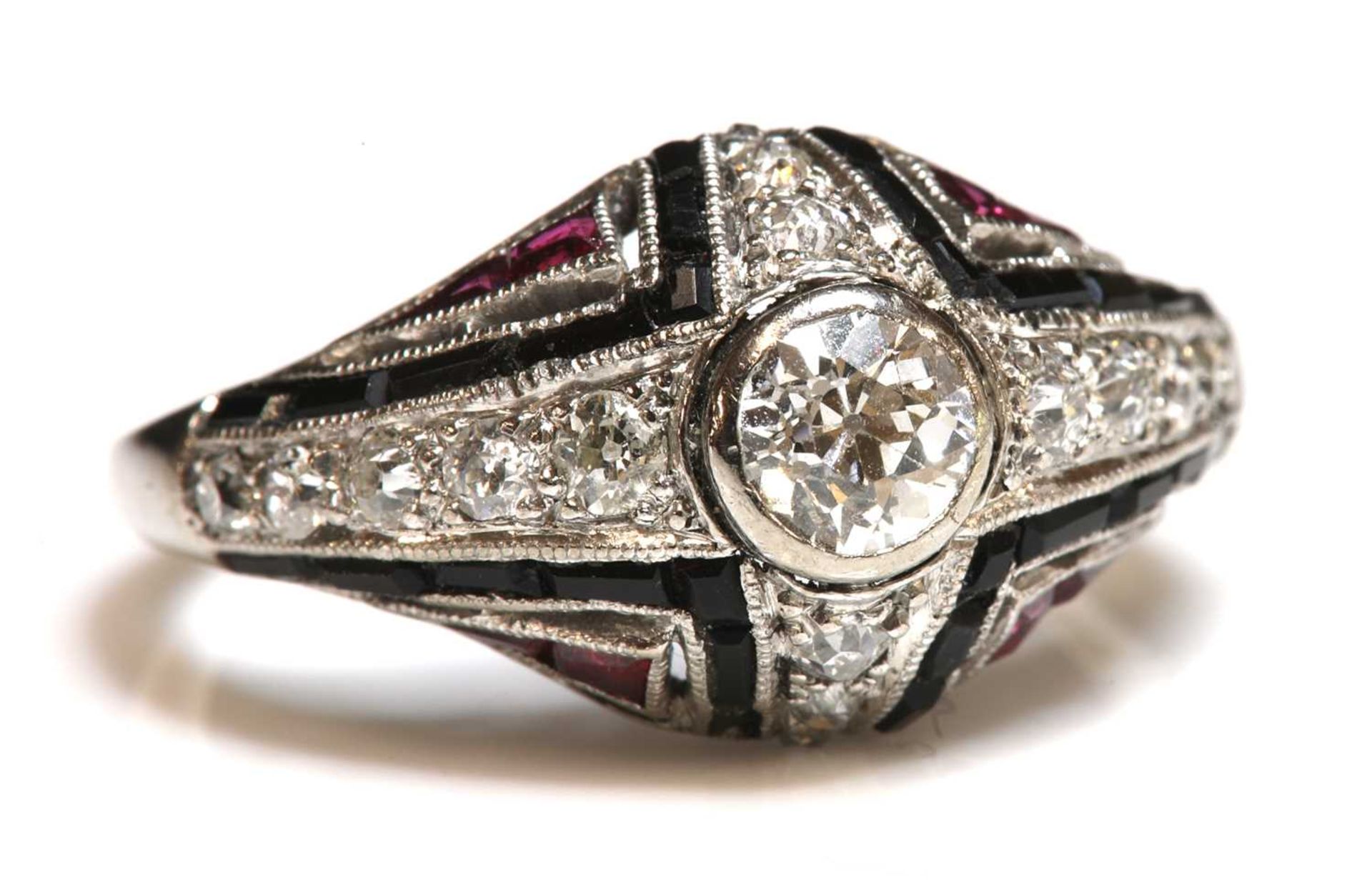 An Art Deco diamond, onyx and synthetic ruby bombé ring, c.1930,