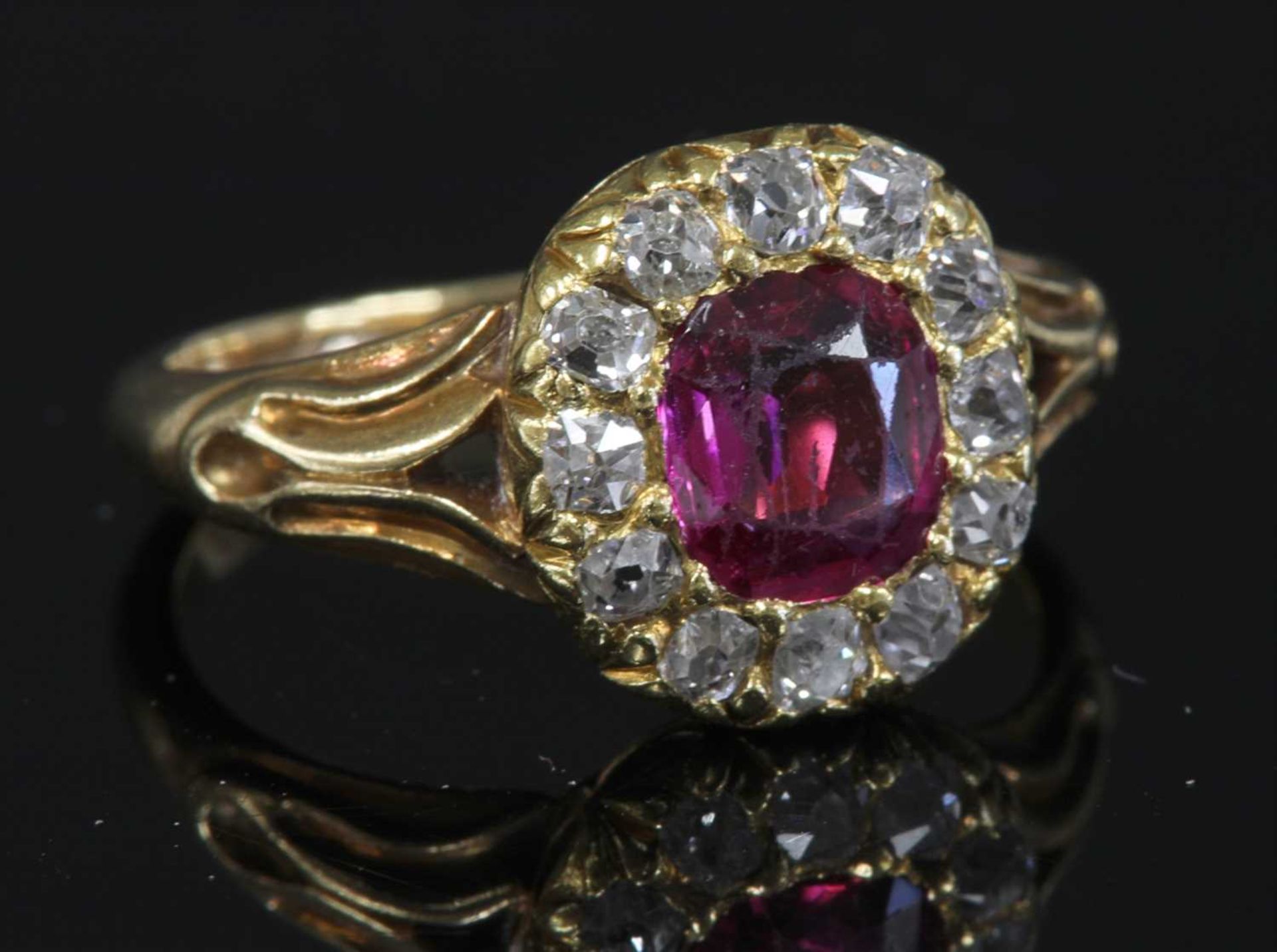 A late Victorian ruby and diamond cushion-shaped cluster ring,