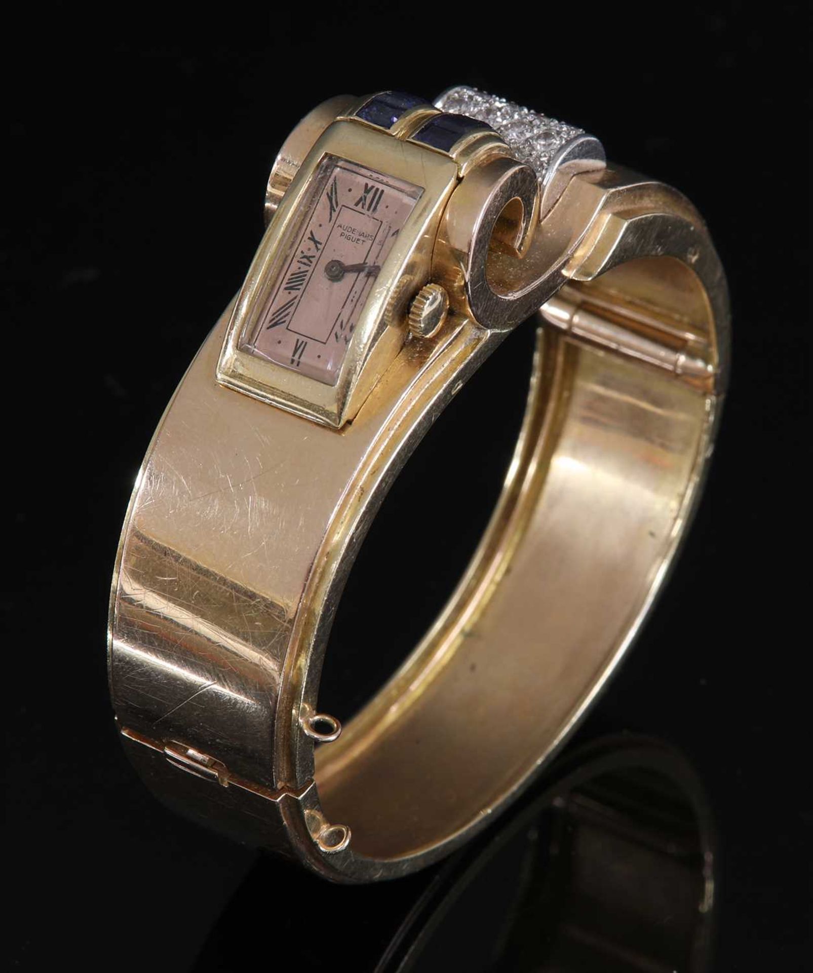 A French odeonesque gold and platinum, sapphire and diamond mechanical bangle watch, c.1940,