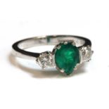 An 18ct white gold emerald and diamond three stone ring,