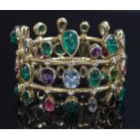 An 18ct gold emerald, aquamarine, amethyst, tourmaline, peridot and diamond hinged bangle,