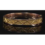 An early 20th century gold hollow hinged bangle,