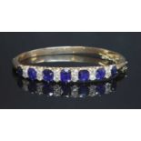 A late Victorian sapphire and diamond hinged bangle, c.1890,