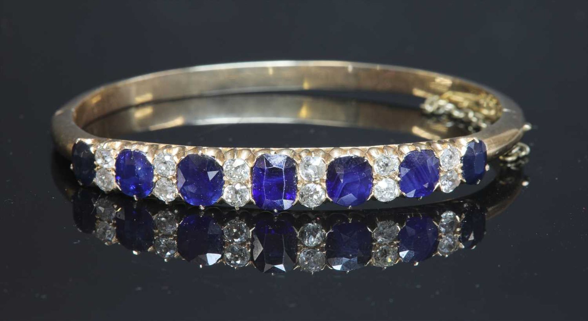 A late Victorian sapphire and diamond hinged bangle, c.1890,