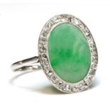 An Art Deco white gold jade and diamond oval cluster ring,