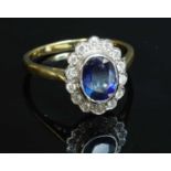 An 18ct gold sapphire and diamond oval cluster ring,