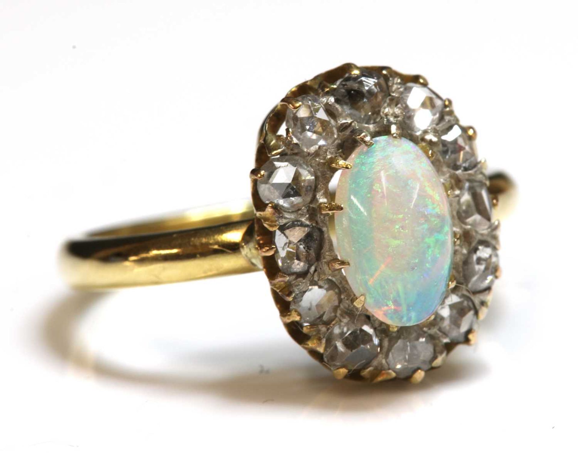 A gold opal and diamond oval cluster ring,