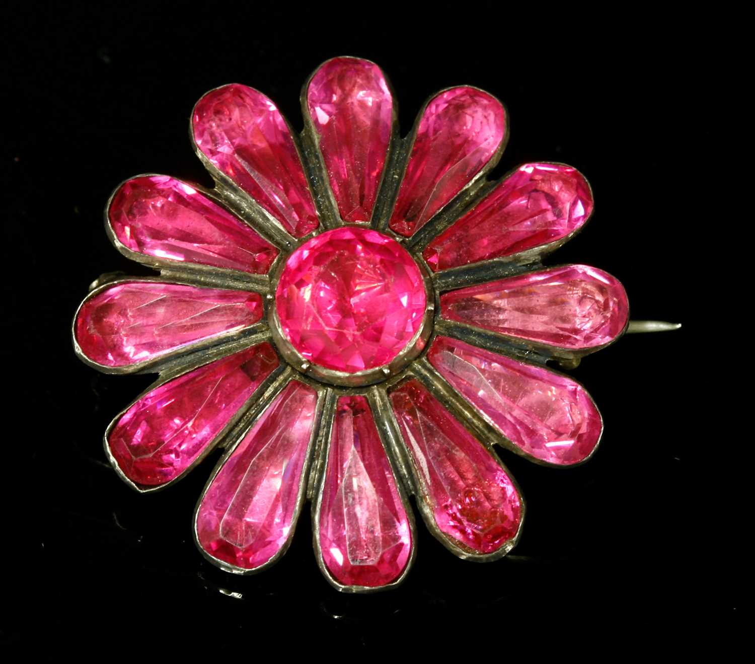 A Georgian silver, pink foil-backed paste flower head brooch,