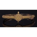 A Victorian Archaeological Revival Etruscan-style gold hinged bangle, c.1870,