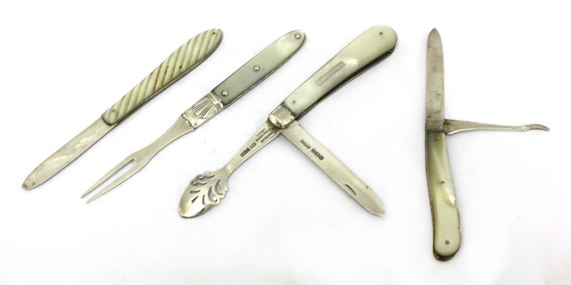 Three silver and mother-of-pearl folding fruit knives and a fork,