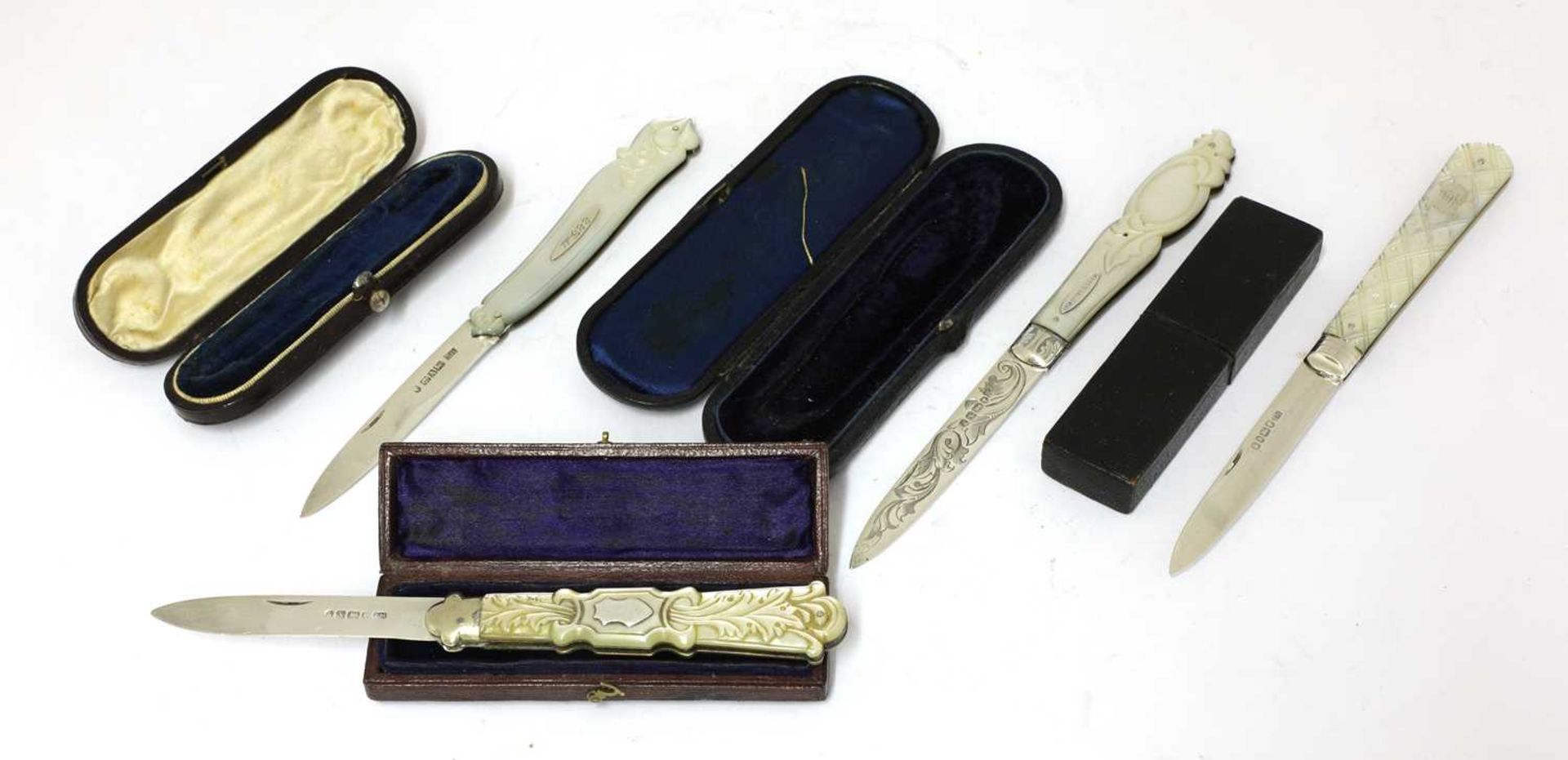 Four Victorian carved mother-of-pearl and silver folding fruit knives,