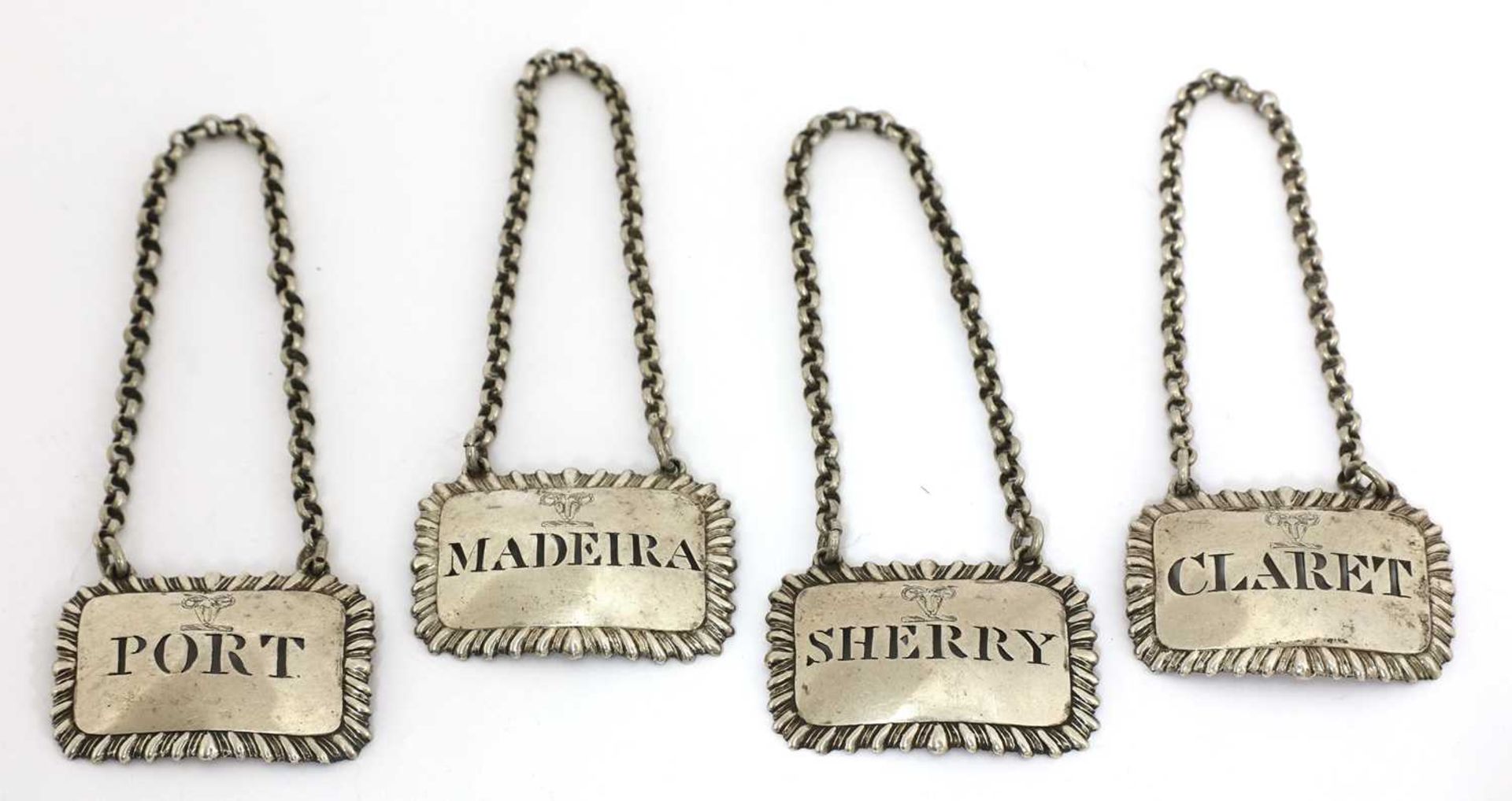 A set of four George III silver wine labels