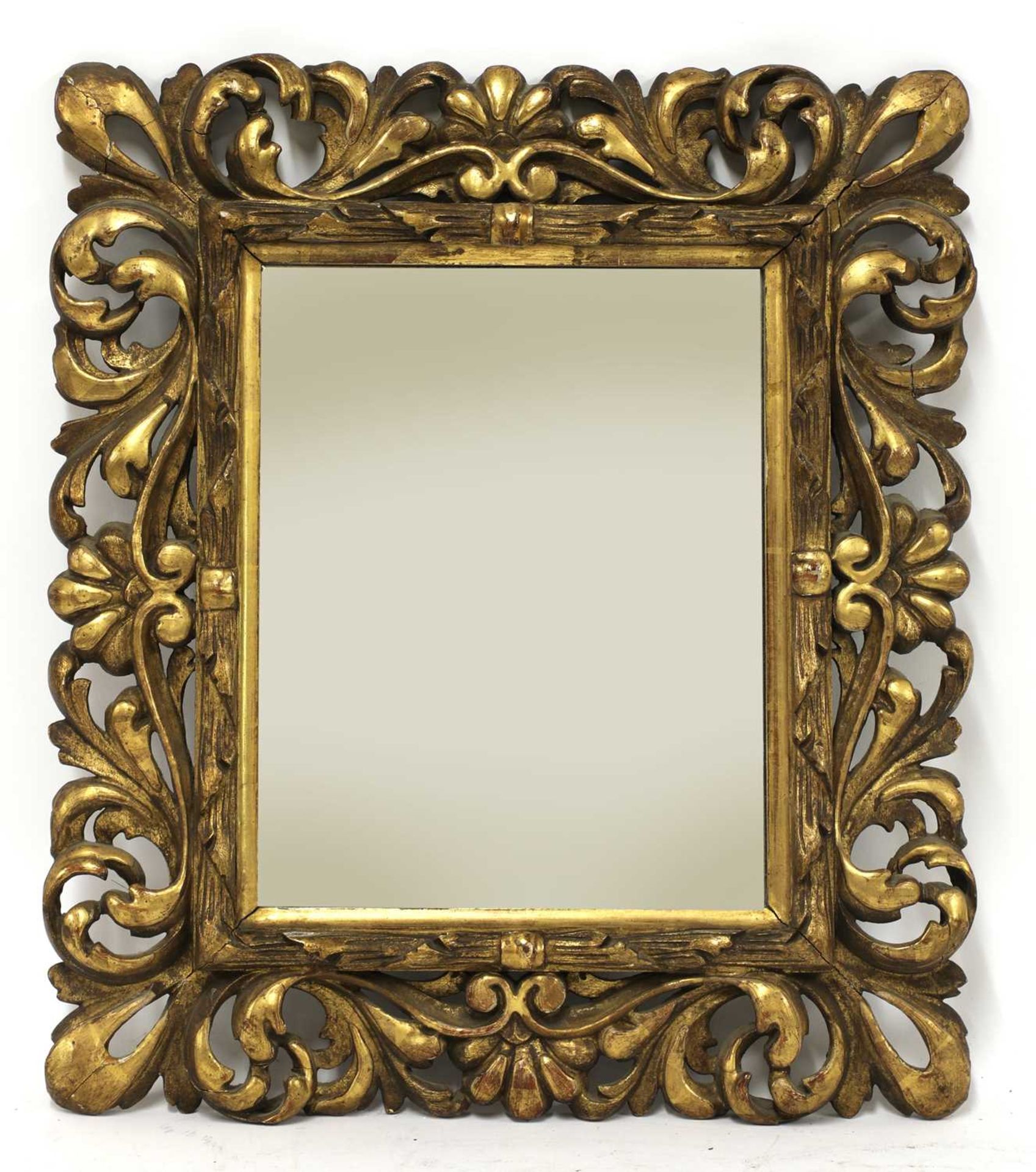 A carved giltwood wall mirror,