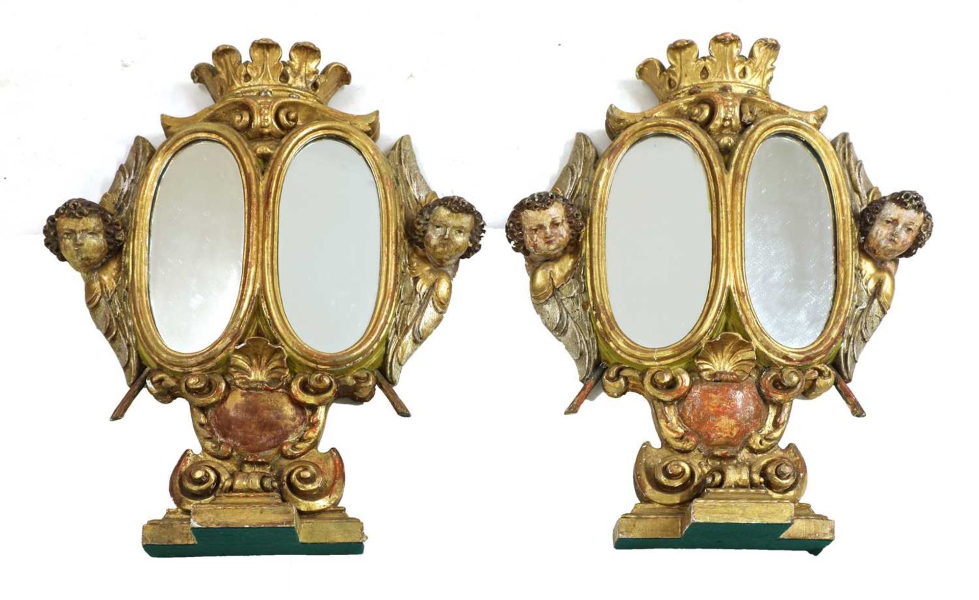 A pair of giltwood reliquary stand mirrors,