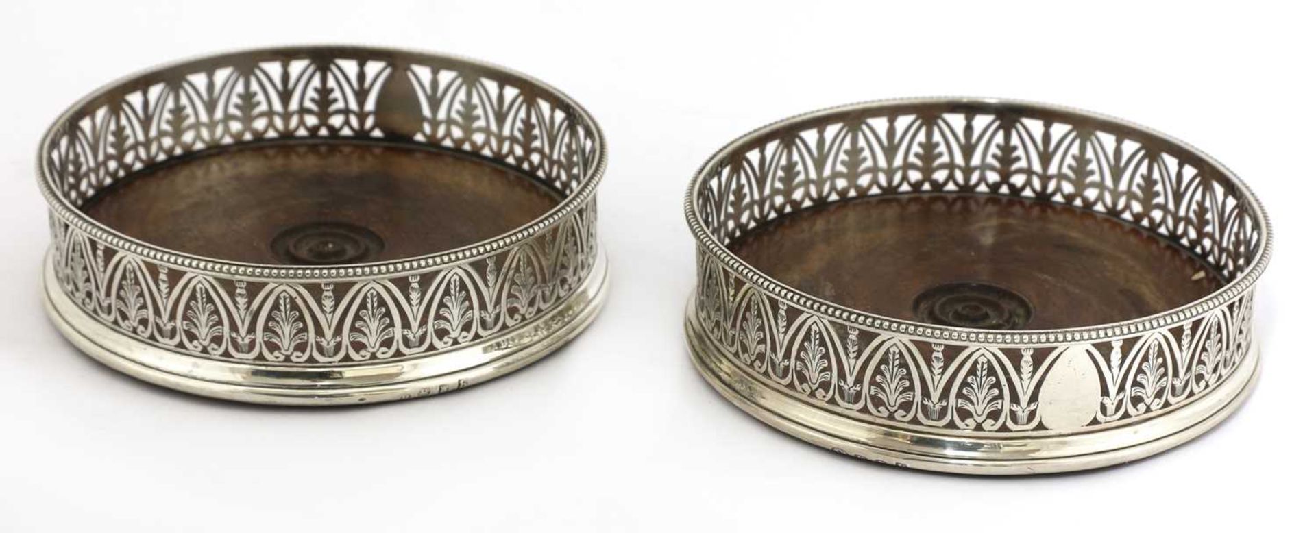 A pair of George III silver wine coasters,