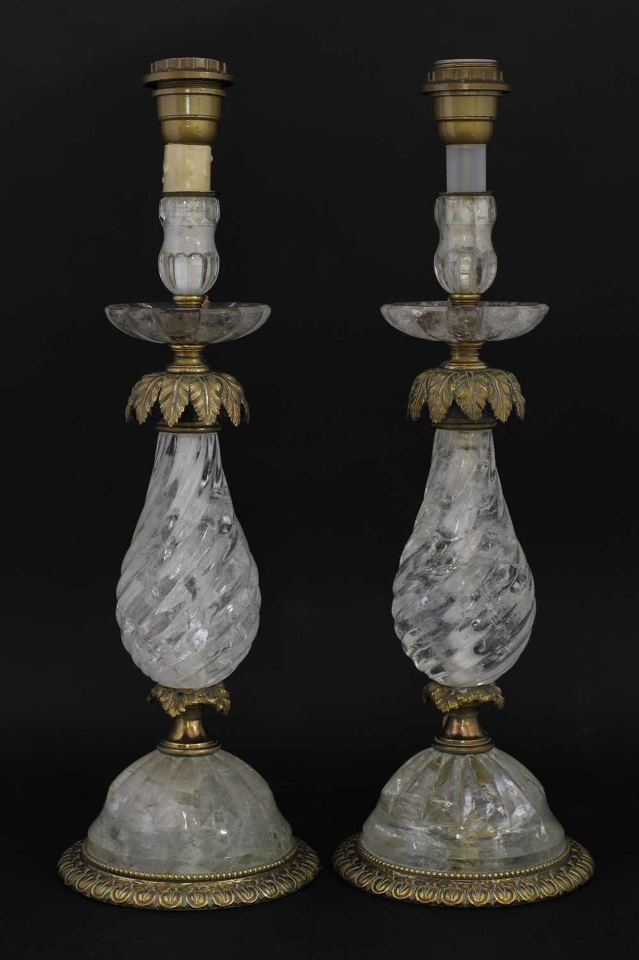 A pair of rock crystal and bronze candlesticks,