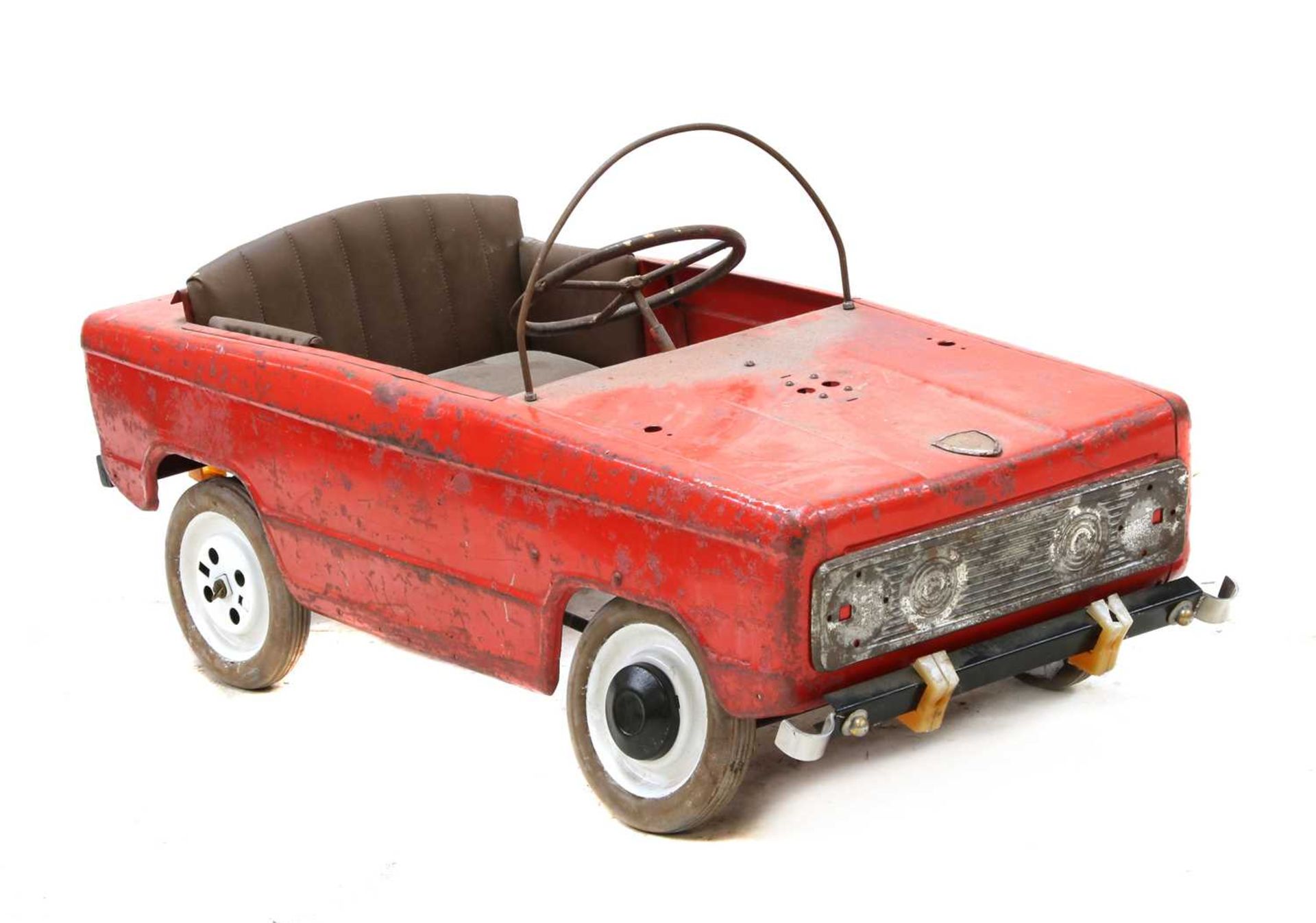 A red painted tinplate pedal car by Moskvich,