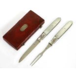A mother-of-pearl and silver folding fruit knife and fork set,