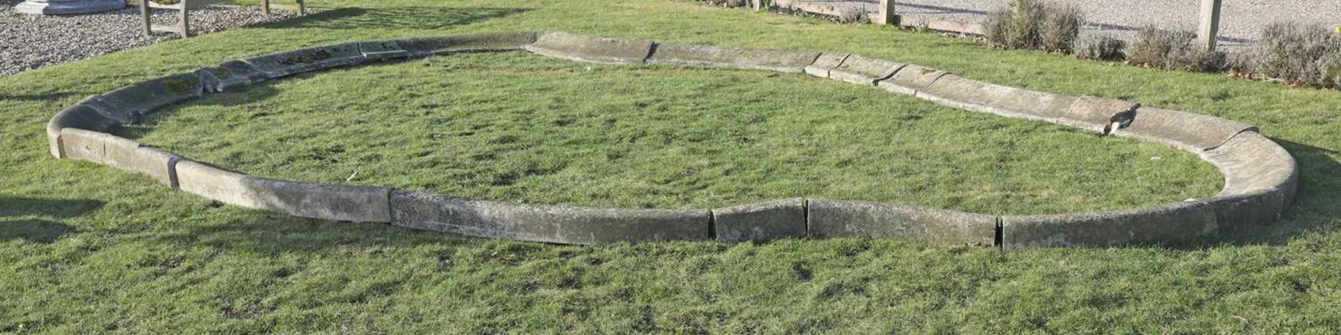 A large sectioned limestone pond surround,